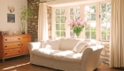 stone cottage interior lounge with with sunshine streaming throu